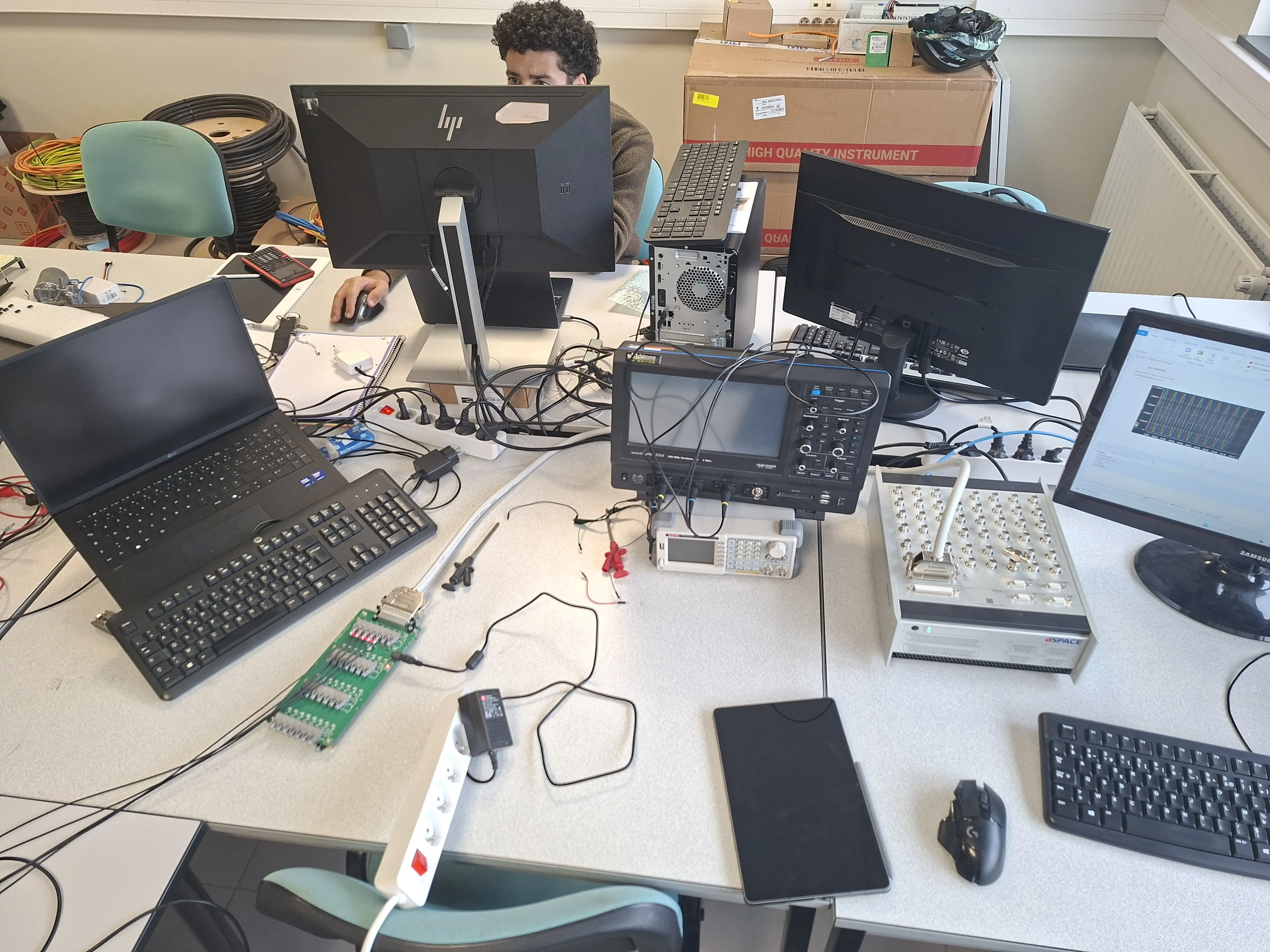 Lab bench with dSpace MicroLabBox II, oscilloscope, ControlDesk traces and a Danfoss fibre interface card