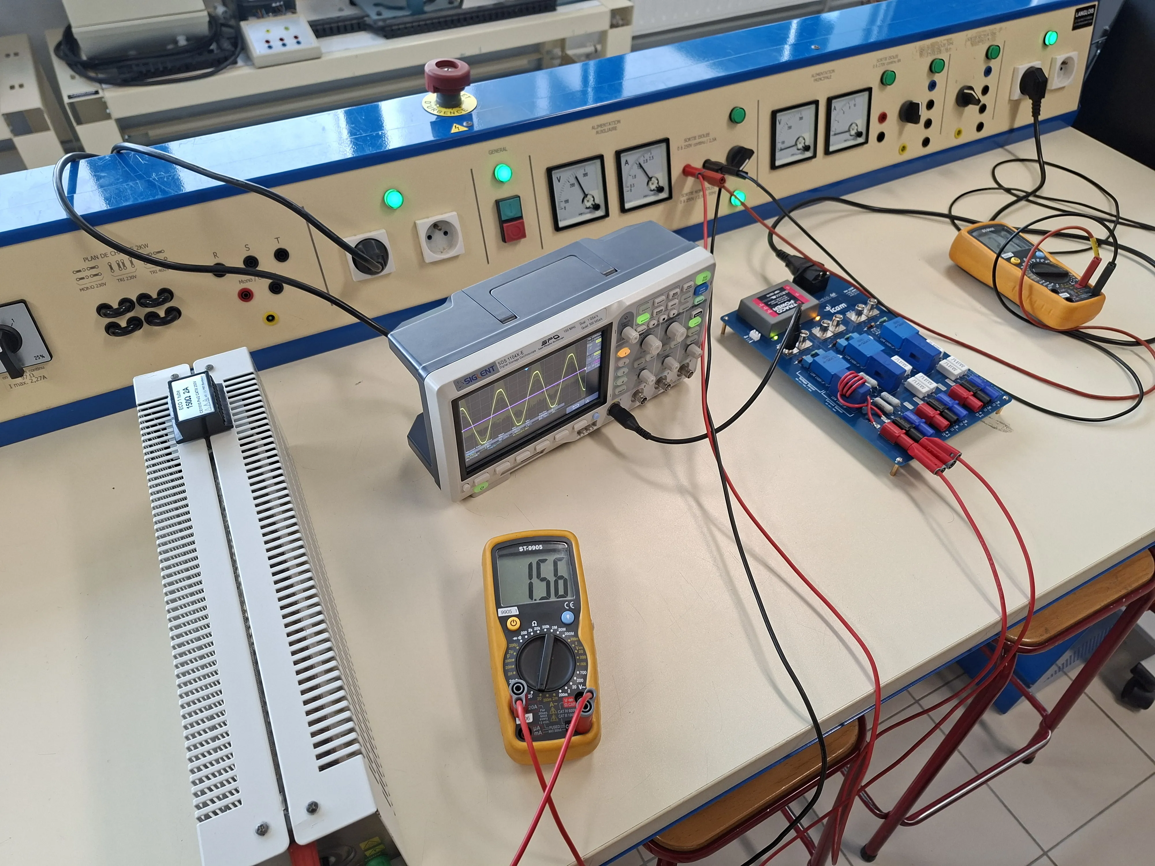 Sensing board on a teaching bench, three-phase sine on a Siglent scope, 15.6 V on the multimeter