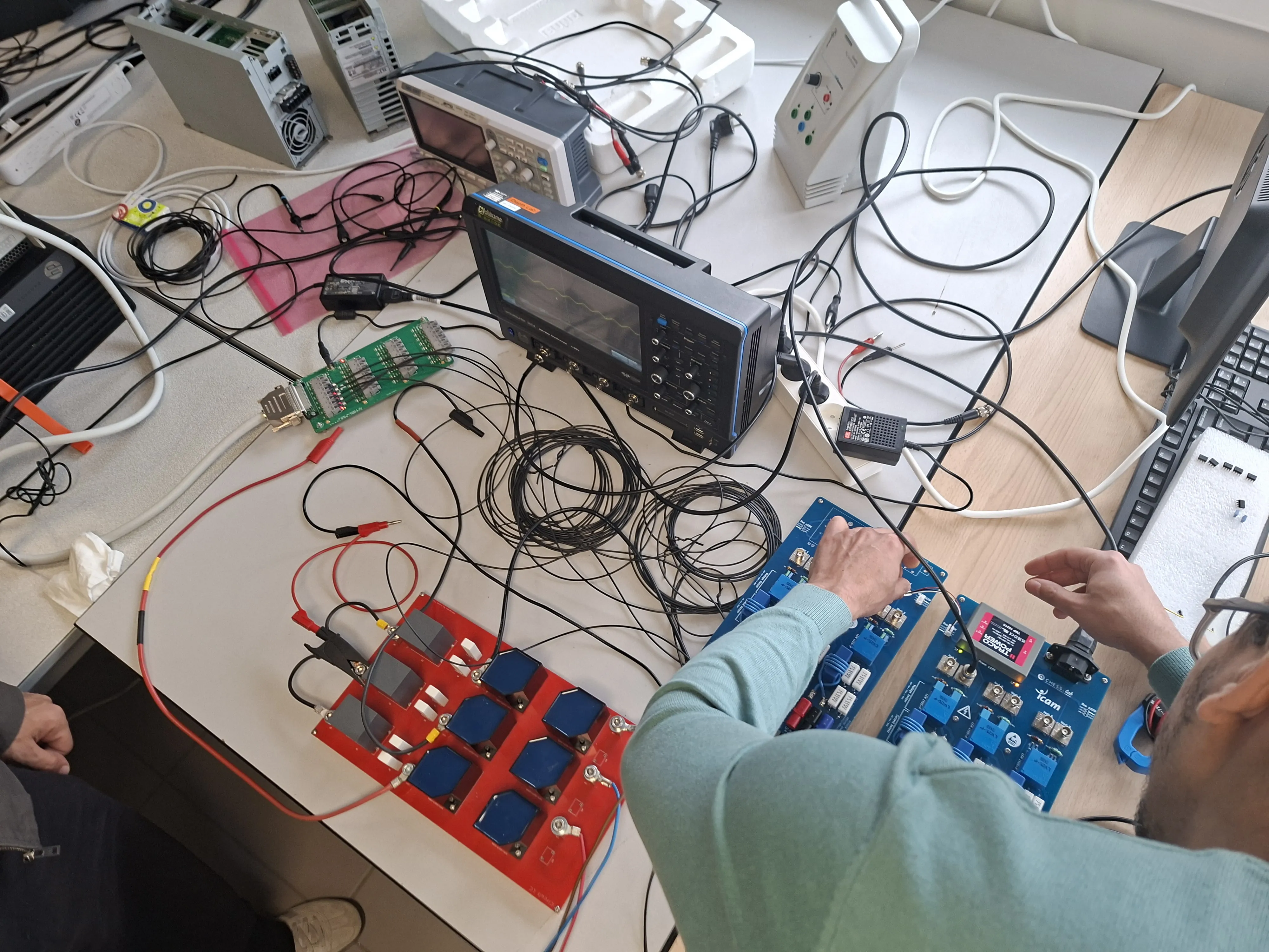 Red LC filter board with hexagonal inductors next to blue Icam voltage and current sensing boards